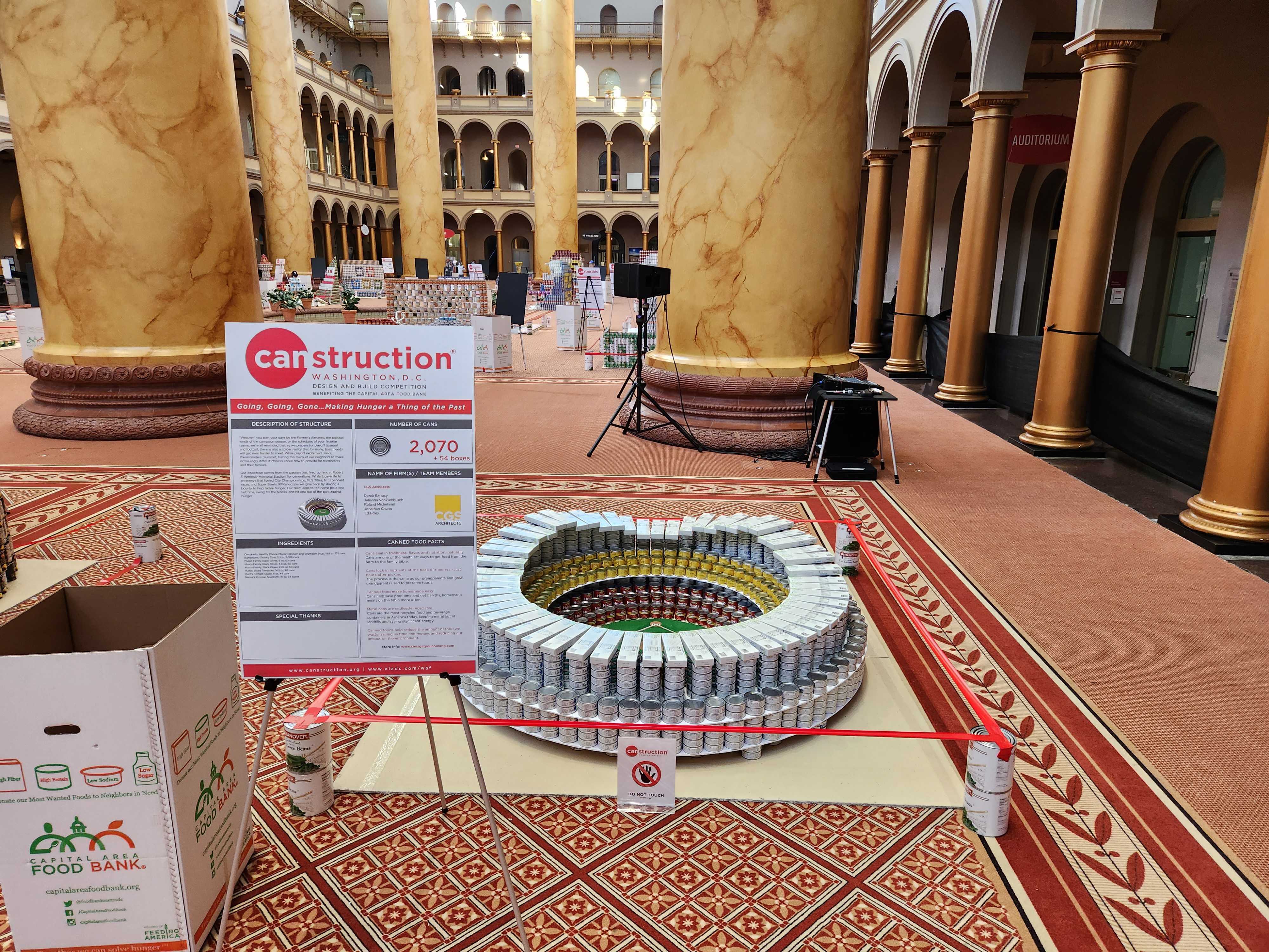 Image of canned food sculpture in shape of a soccer stadium