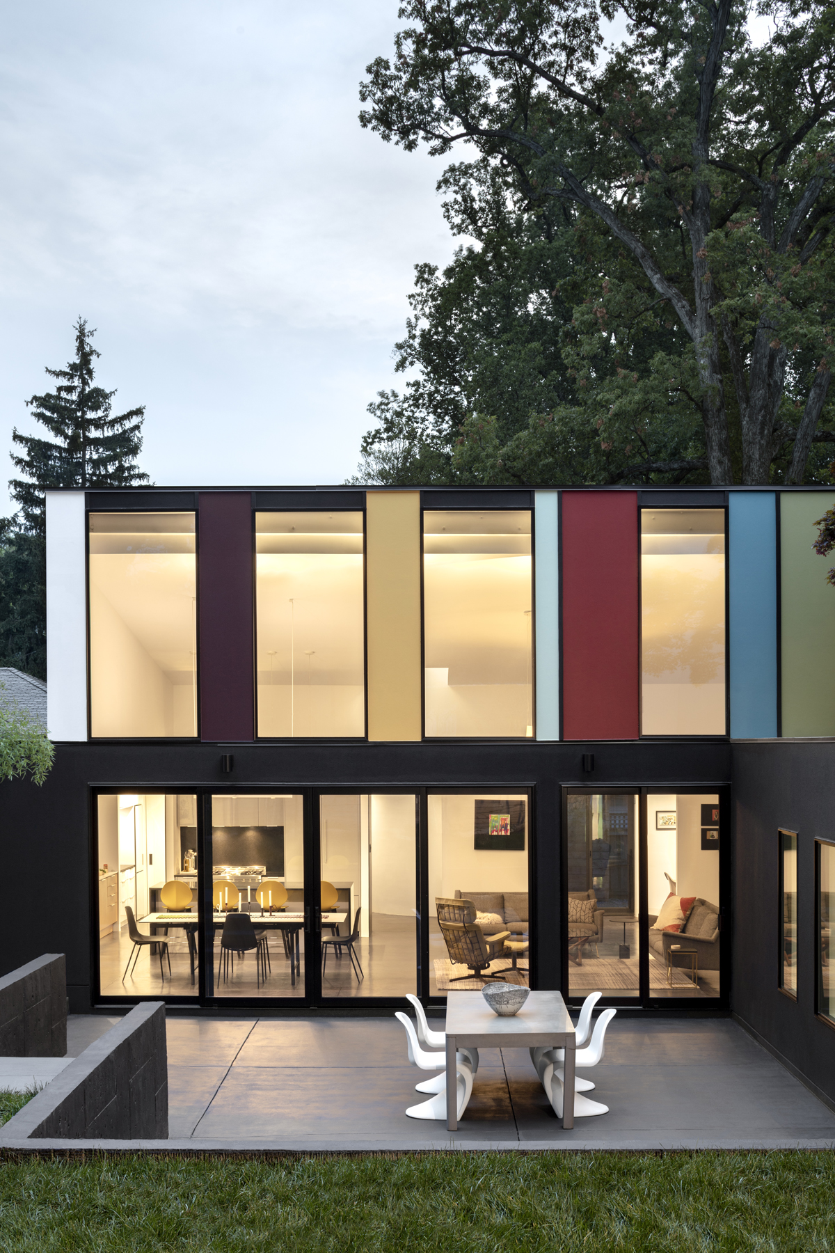 Renovated exterior on modern house with colorful panels and large windows